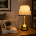 3-way dimmable touch table lamp with lilen fabric , modern gold bedside lamp on a wooden side table in a cozy living room