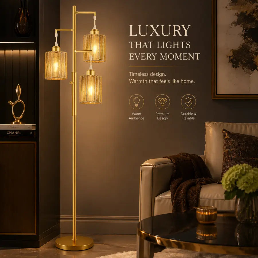 A luxury three-light floor lamp with gold-finished metal frames and warm woven amber glass shades, shown in a styled living room next to a sofa with promotional text on the wall.