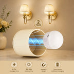 A 2-pack of cylindrical magnetic wireless charging stands in a warm beige room setting. One stand is open, showing a blue magnetic field graphic inside, and the other is shown beside it.
