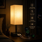 A lit rectangular table lamp with a warm beige fabric shade and black base sits on a bedside table, charging a smartphone and a small device via USB. The scene is dimly lit, with a nightstand, framed wall art, and a vertical panel of feature icons on the right describing dimmability, touch control, fast charging, and eye-friendly lighting.