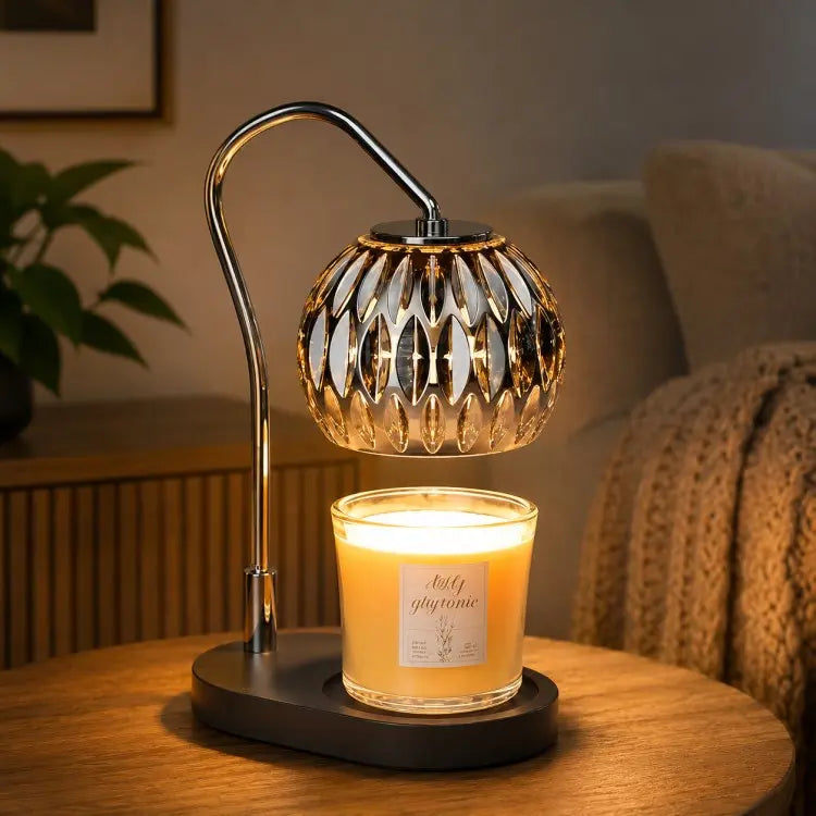 Black candle warmer lamp with timer and dimmer warming a scented jar candle on a wooden table in a modern living room