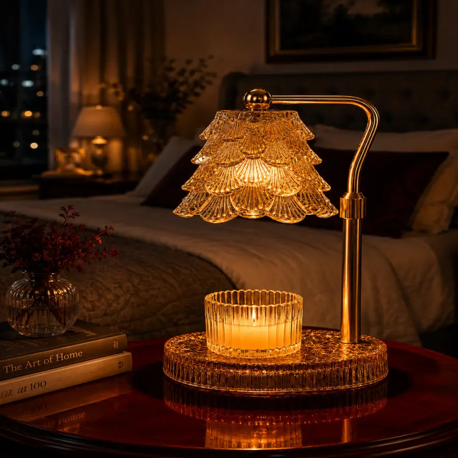 A warm golden table lamp with a tiered crystal shade and a matching crystal candle holder on a round base, placed on a dark wooden table in a softly lit bedroom setting.