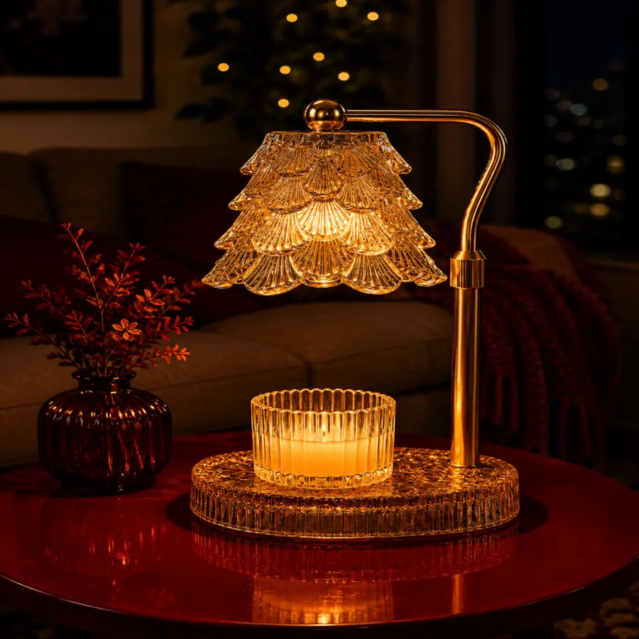 A lit crystal table lamp with a tiered glass shade and a matching glass candle holder on a round base, placed on a red table in a warmly lit living room setting.