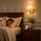 A woman sleeps in bed next to a bedside table with a lit wall sconce, flowers in a vase, and a remote control. Overlaid text shows sleep cycle durations: 0.