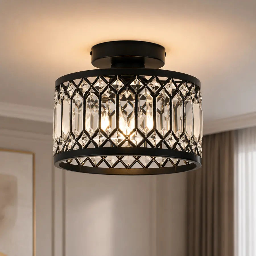 A semi-flush mount drum ceiling light fixture with a black metal frame and clear crystal prisms, illuminated with a warm glow in a home interior setting.