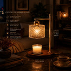A candle warmer lamp with a brass-toned metal stand and a textured clear glass shade, shown lit on a dark tabletop with a small candle underneath. White measurement text and arrows overlay the left and right sides of the lamp, and product feature text appears on the left.