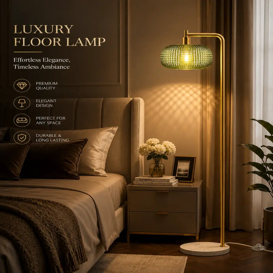 Luxury floor lamp with a gold-finished metal frame and a textured green glass shade, shown illuminated in a modern bedroom setting next to a bed with a bedside table.