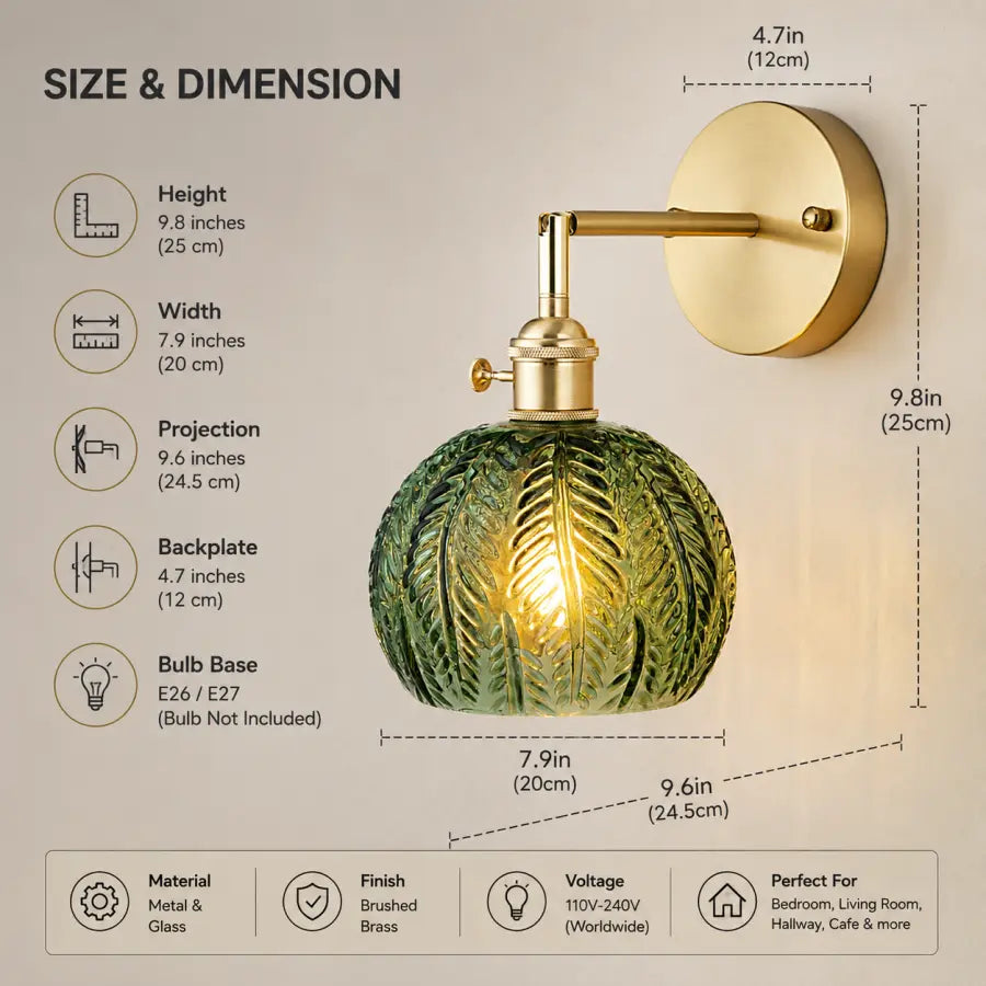 A wall-mounted light fixture with a round green textured glass shade and a brass wall plate and arm, shown with dimension callouts and text listing height, width, projection, backplate, bulb base, material, finish, voltage, and use cases.